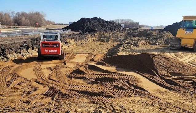 A group of construction workers are working on a road.