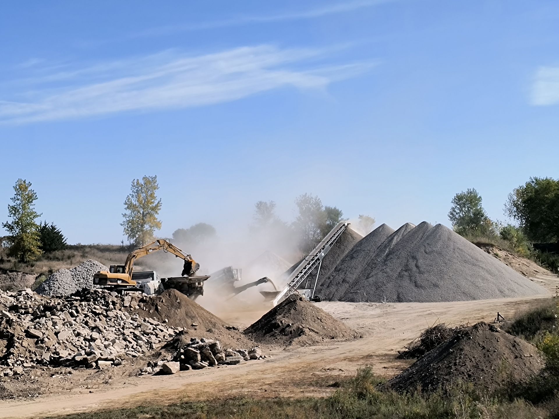 A large pile of dirt is being moved by a bulldozer.