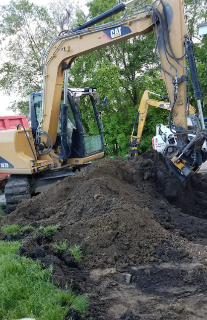 A bulldozer is digging a hole in the ground.