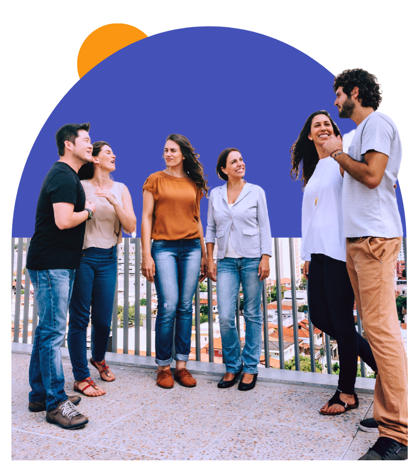 a group of people are standing on a balcony talking to each other.