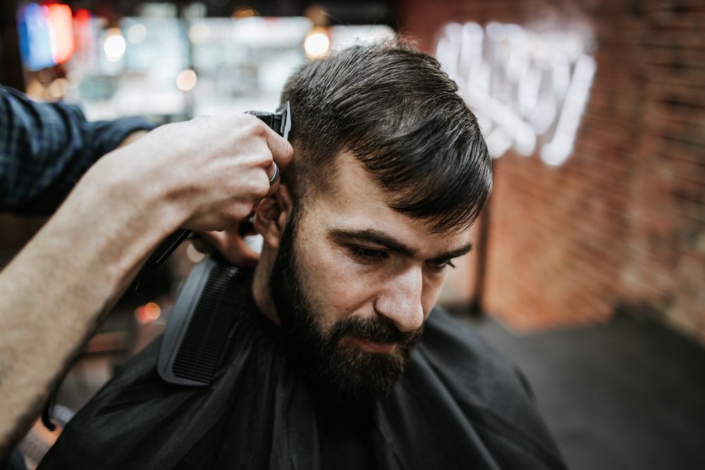 Person Getting a Haircut With Clippers at a Barbershop — The Gentleman's Barber QLD in Toowoomba City, QLD