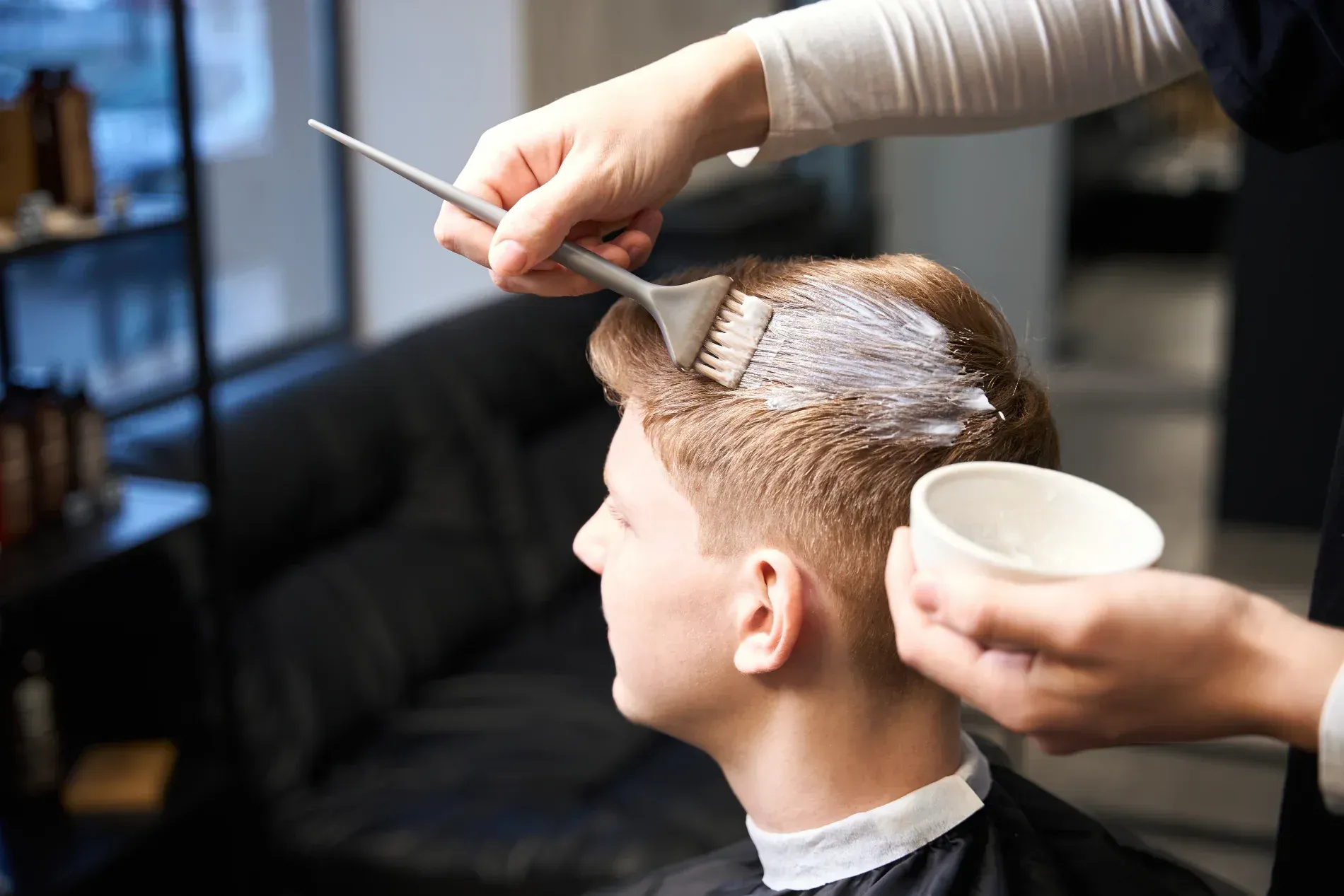 Hairdresser applying dye to a client's hair in a salon — The Gentleman's Barber QLD in Toowoomba City, QLD