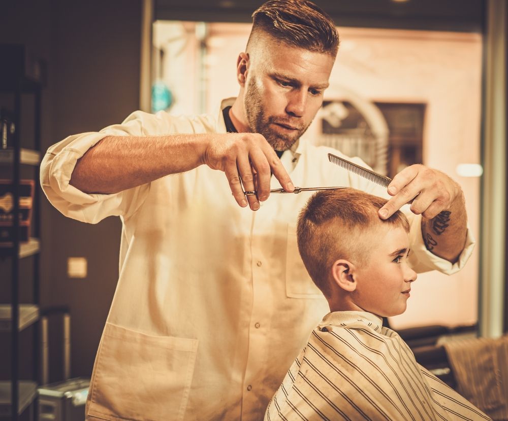 Barber Cutting a Child's Hair in a Barber Shop, Using Scissors and a Comb — The Gentleman's Barber QLD in Toowoomba City, QLD