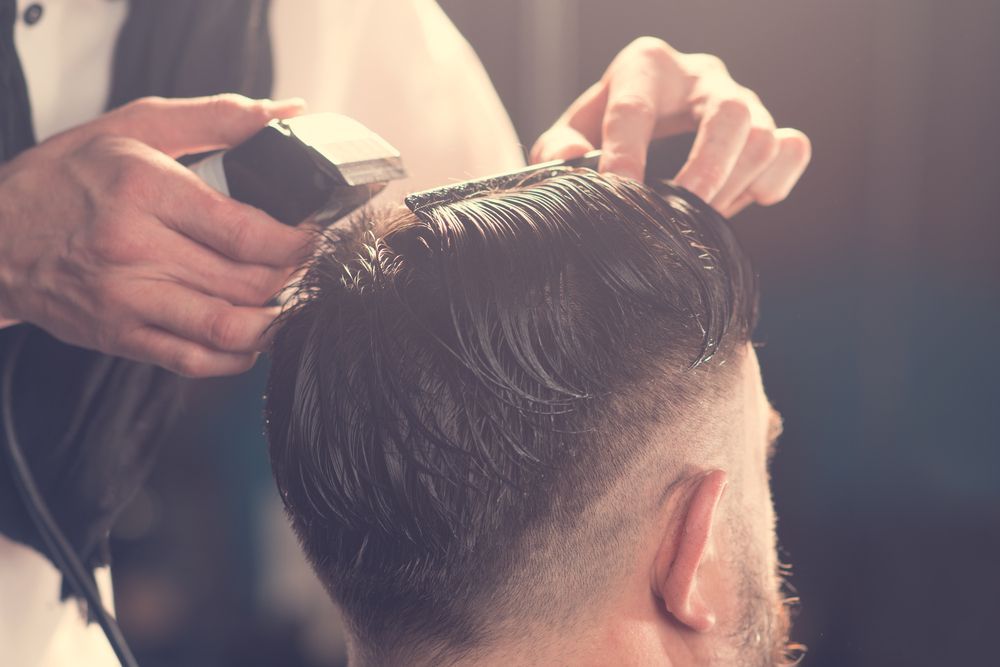 Barber Giving a Man a Fade Haircut With Clippers — The Gentleman's Barber QLD in Toowoomba City, QLD