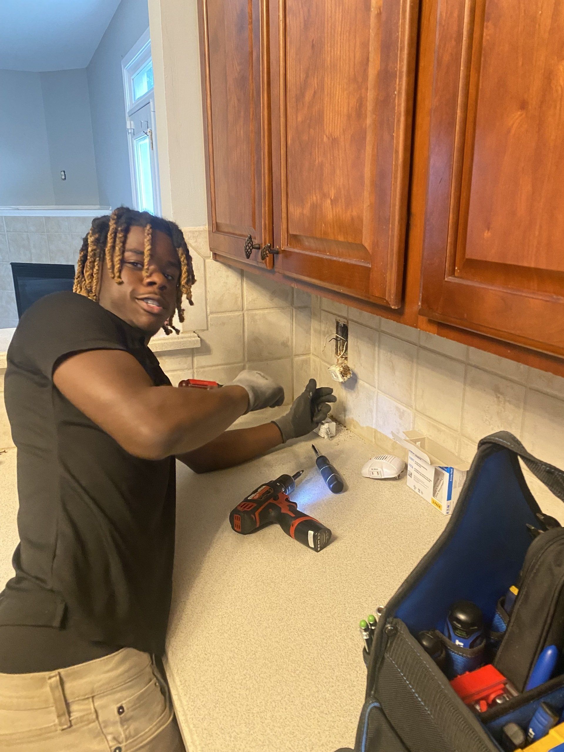 Man Repairing An Electrical Outlet