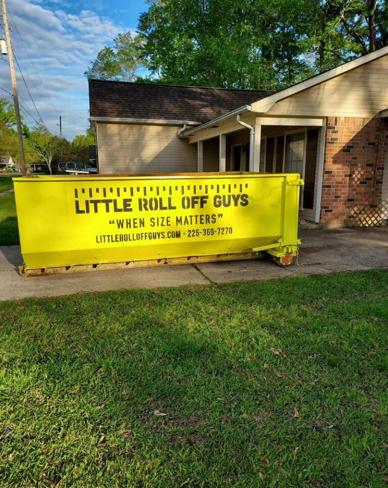 A yellow dumpster with the words little roll off guys on it