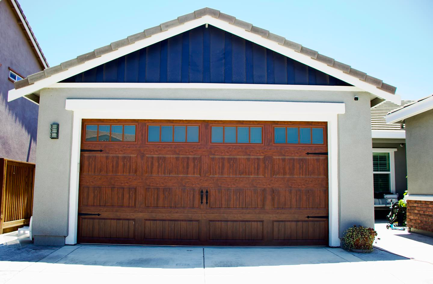 A house with a wooden garage door and a blue roof