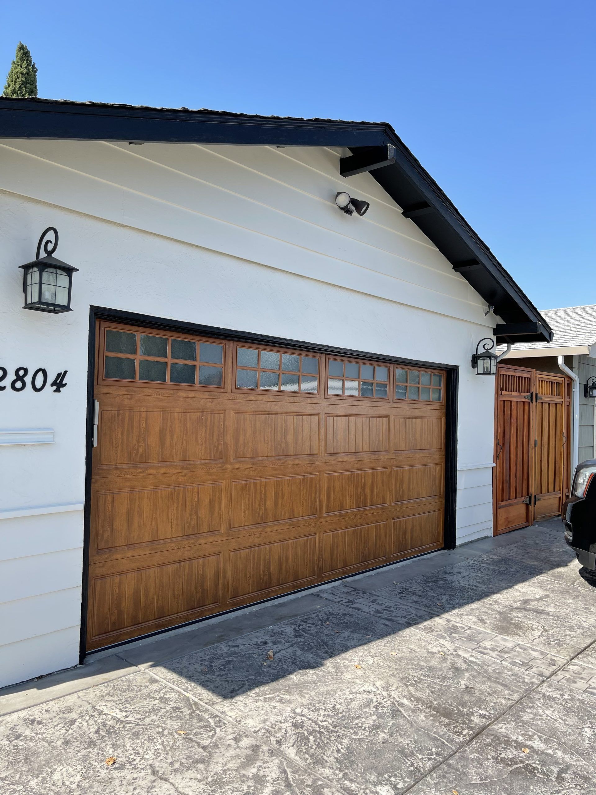 A white house with a large wooden garage door