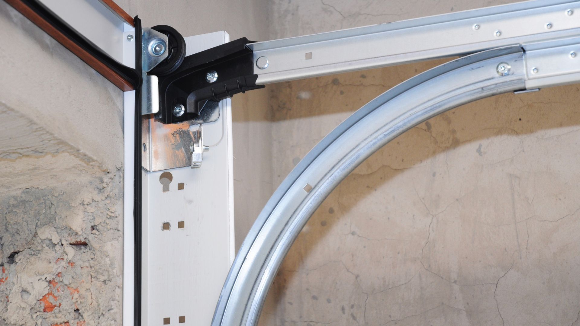 A close up of a garage door with a broken hinge