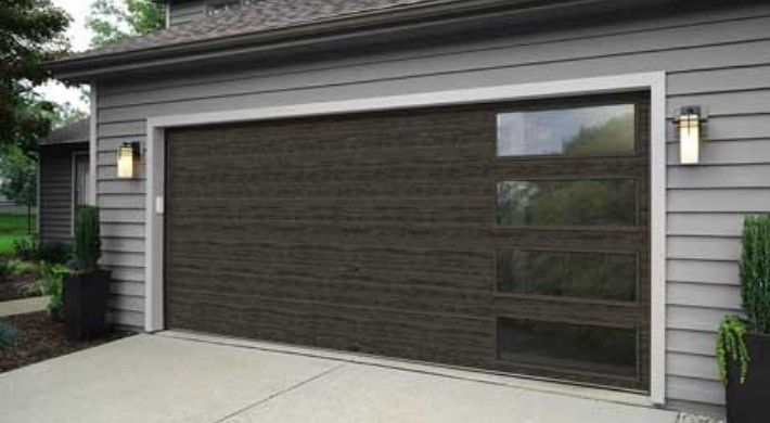 A garage door with a large window on the side of a house.