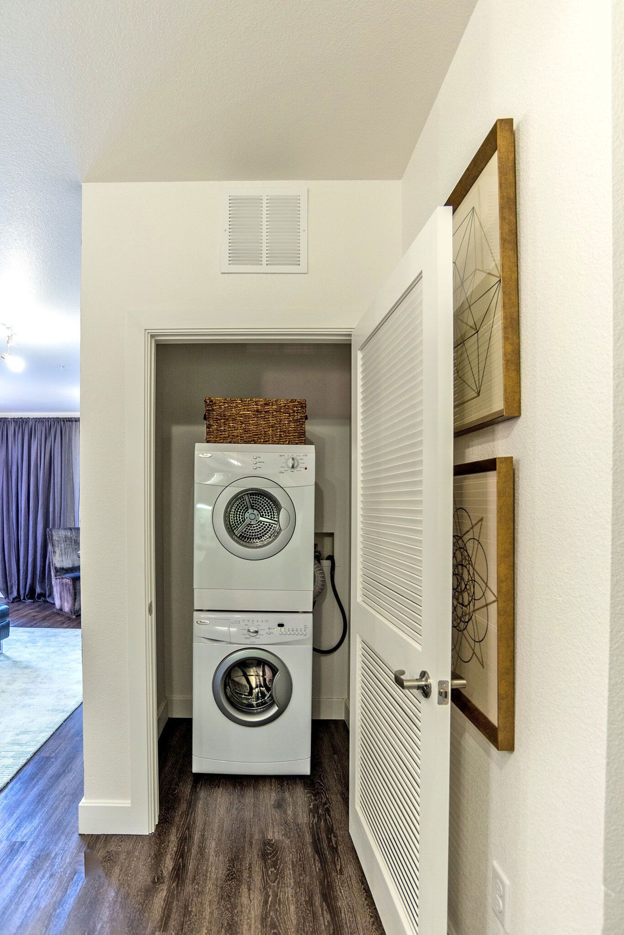In-unit laundry closet with stacked washer and dryer.