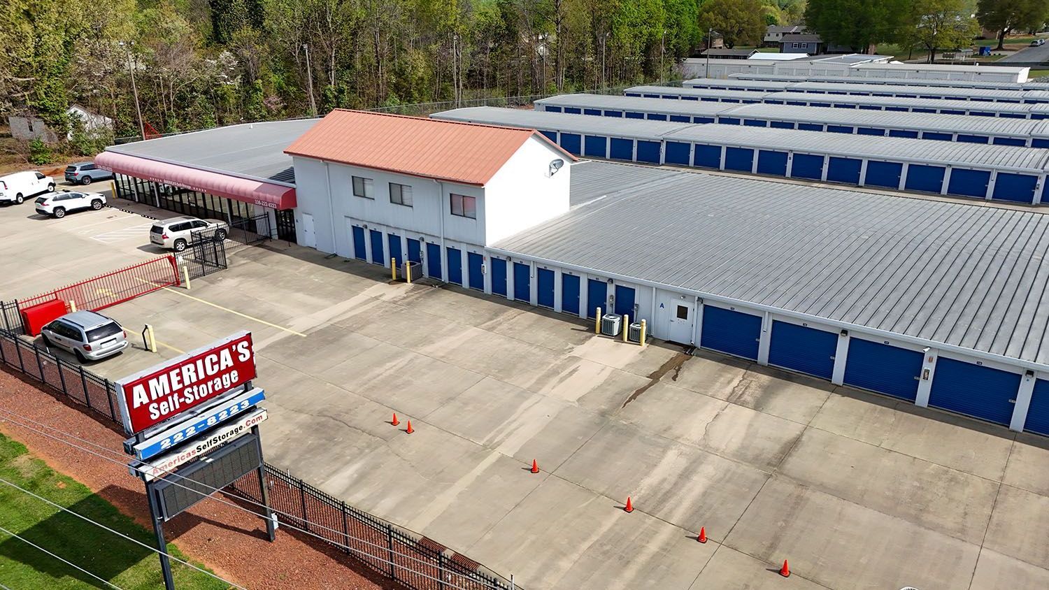 An aerial view of a self-storage facility with blue doors that provides climate controlled storage in Burlington, NC