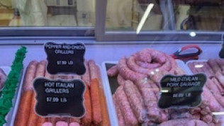 Meat display case with sausages: pepper/onion grillers, hot Italian grillers, mild Italian pork sausage.