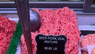 Ground beef, pork, and veal mixture displayed with a sign that reads, 