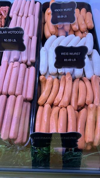 Display case of various sausages: hotdogs, Weißwurst, and German wieners.