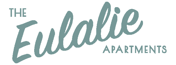 Logo for "The Eulalie Apartments" in teal, cursive script text with block lettering for the word "APARTMENTS."
