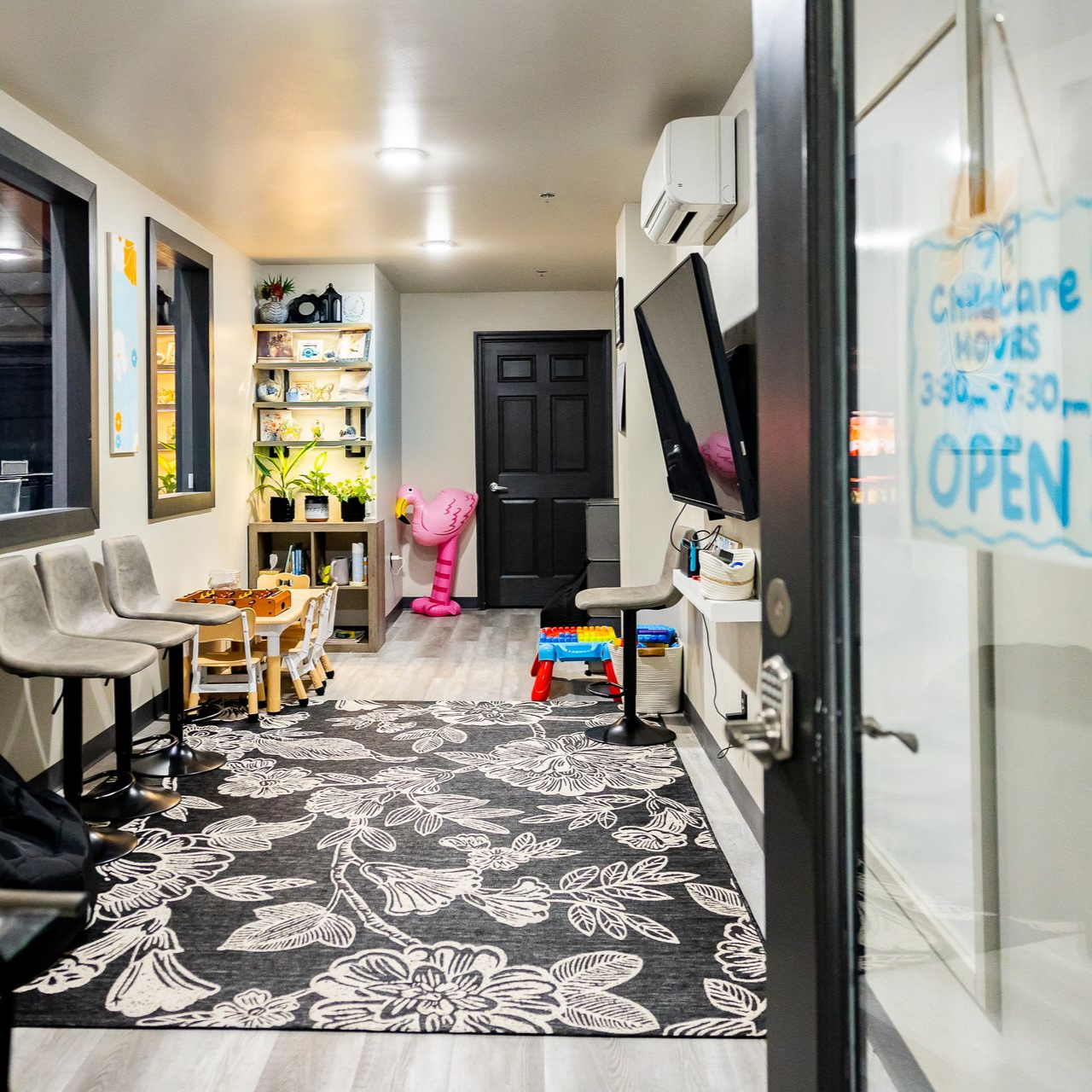 Freedom Fitness childcare room with play areas, toys, seating, and a bright, kid-friendly environment