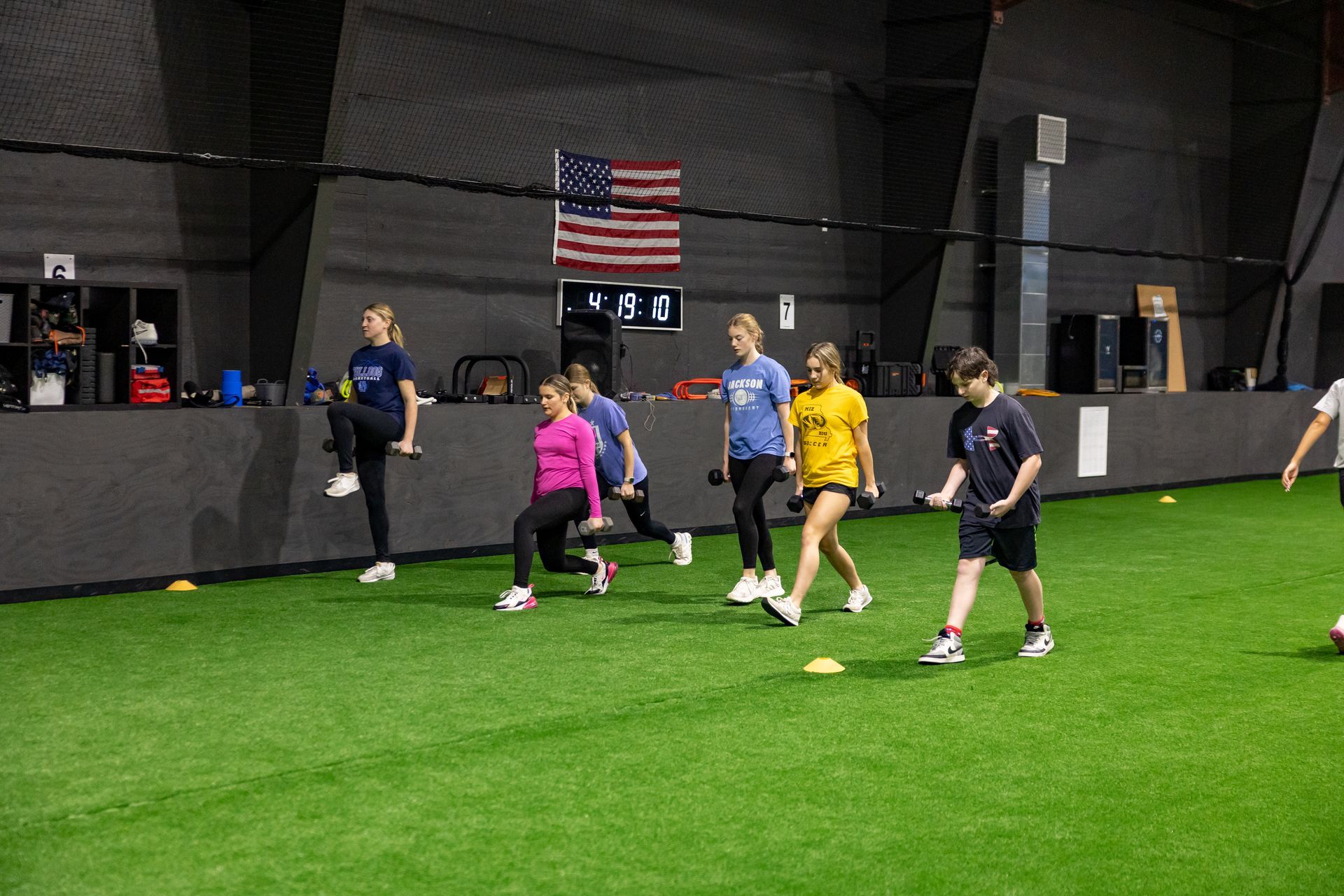 Wide view of the Freedom Fitness gym featuring cardio equipment, weight machines, free weights, and turf space.