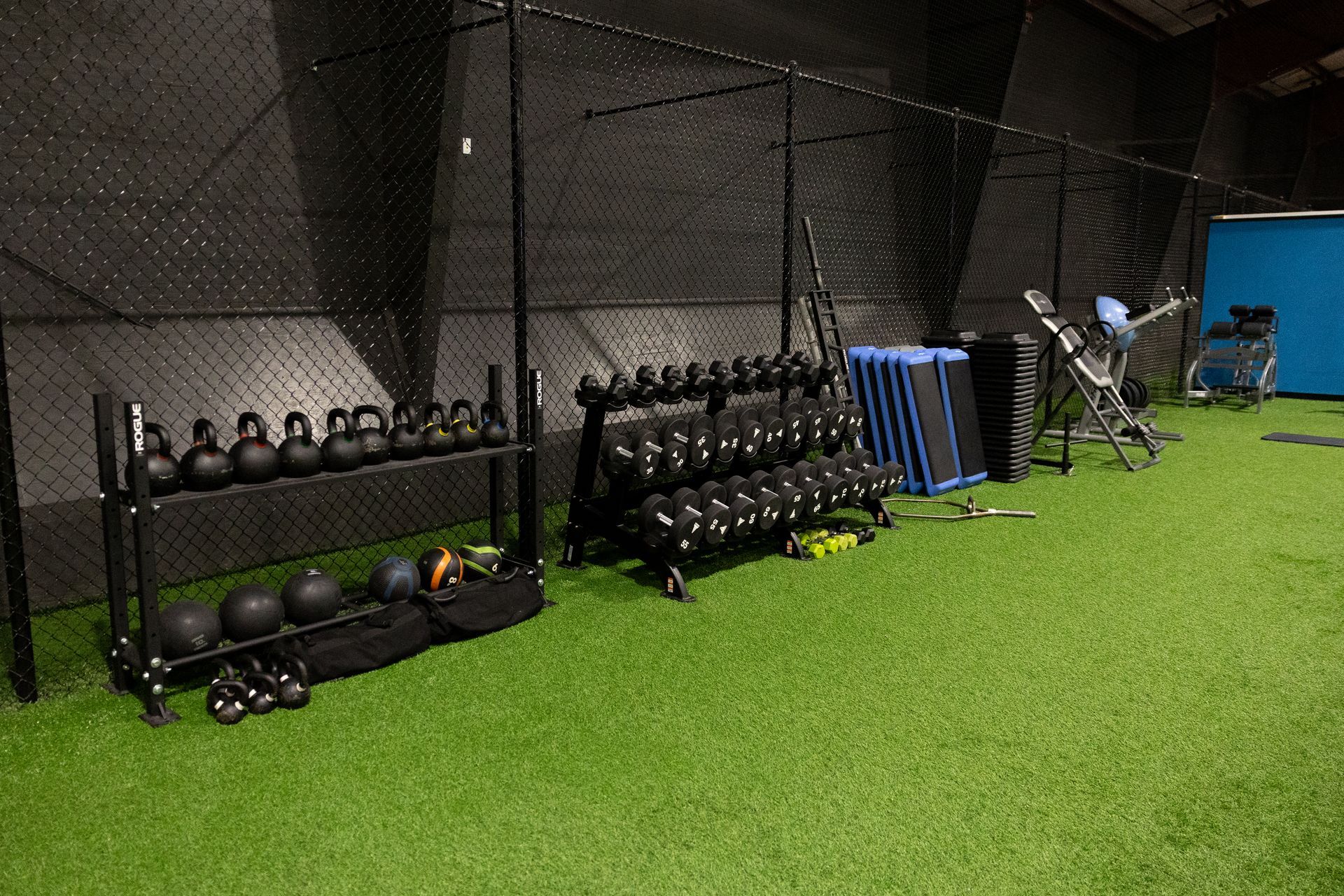 Wide view of the Freedom Fitness gym featuring cardio equipment, weight machines, free weights, and turf space.