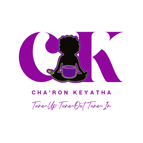 A purple logo with a silhouette of a woman sitting in a lotus position