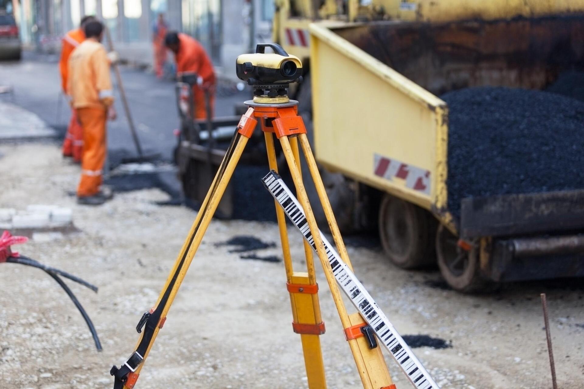a surveyor's tool and workers