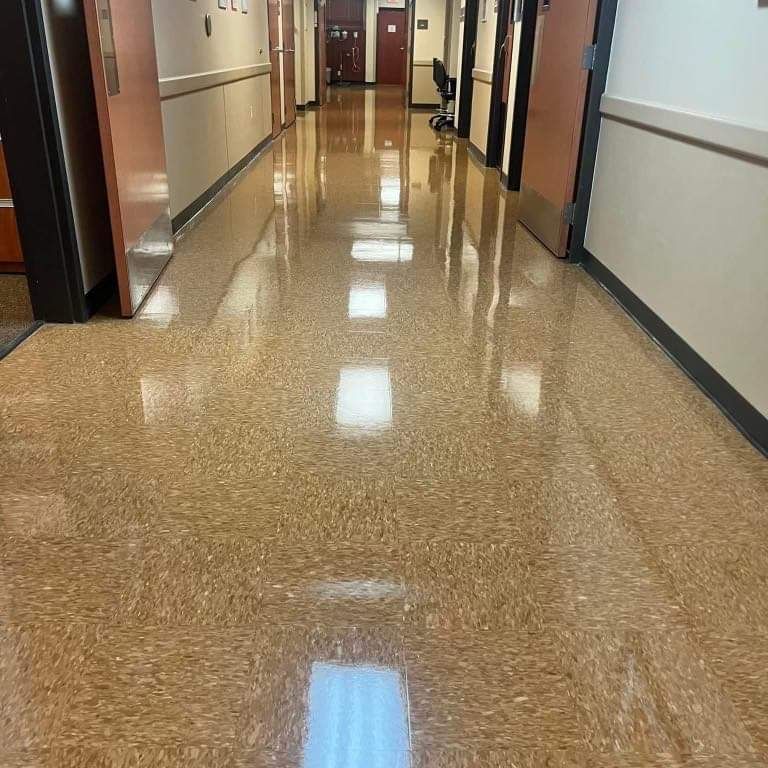 A long hallway in a building with a shiny floor