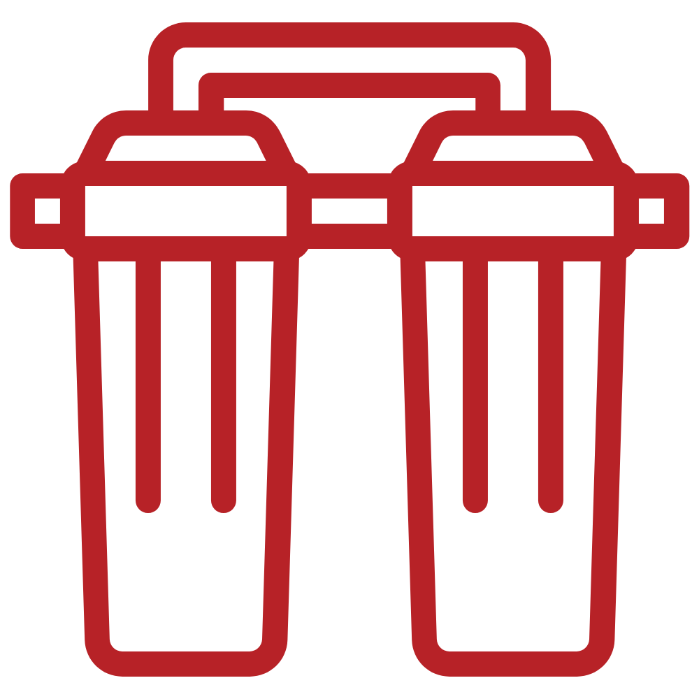 Red outline of a water filter system, composed of two cylindrical filter housings.