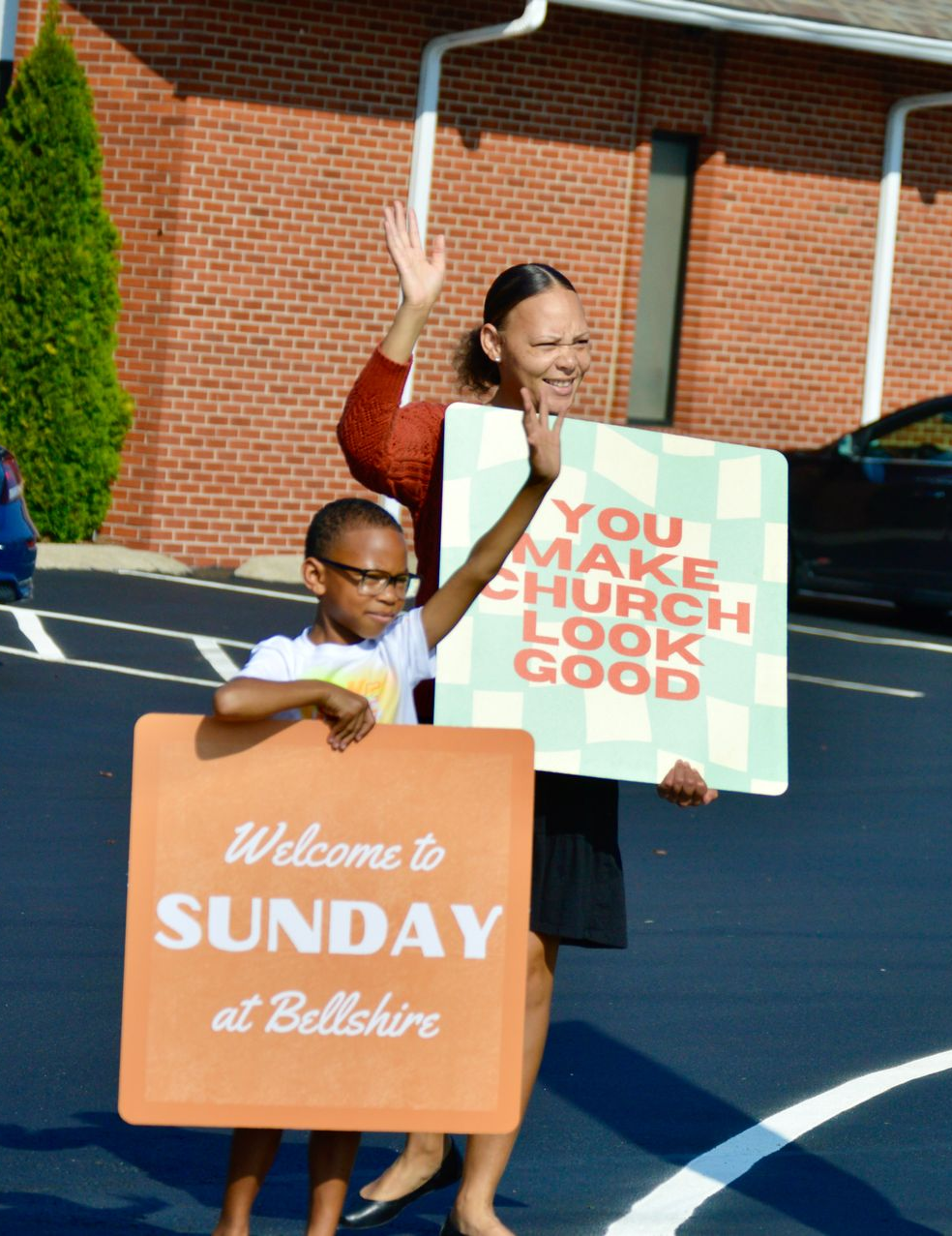 A large auditorium with rows of chairs and a projector screen.