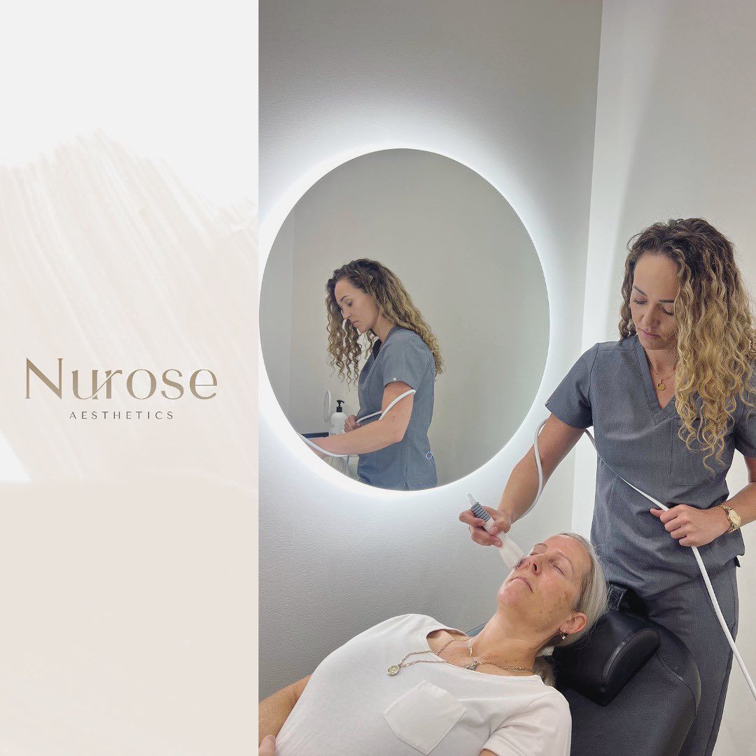 A Woman is Laying in a Chair in Front of a Mirror While Another Woman Stands Behind Her — Nurose Aesthetics in Nundah, QLD