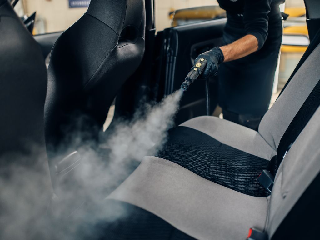 auto detail tech steaming seats before removing stains