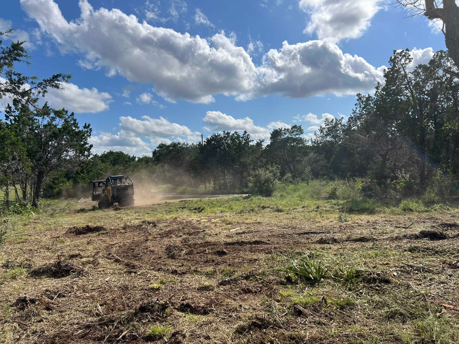 A bulldozer is moving dirt in a field.