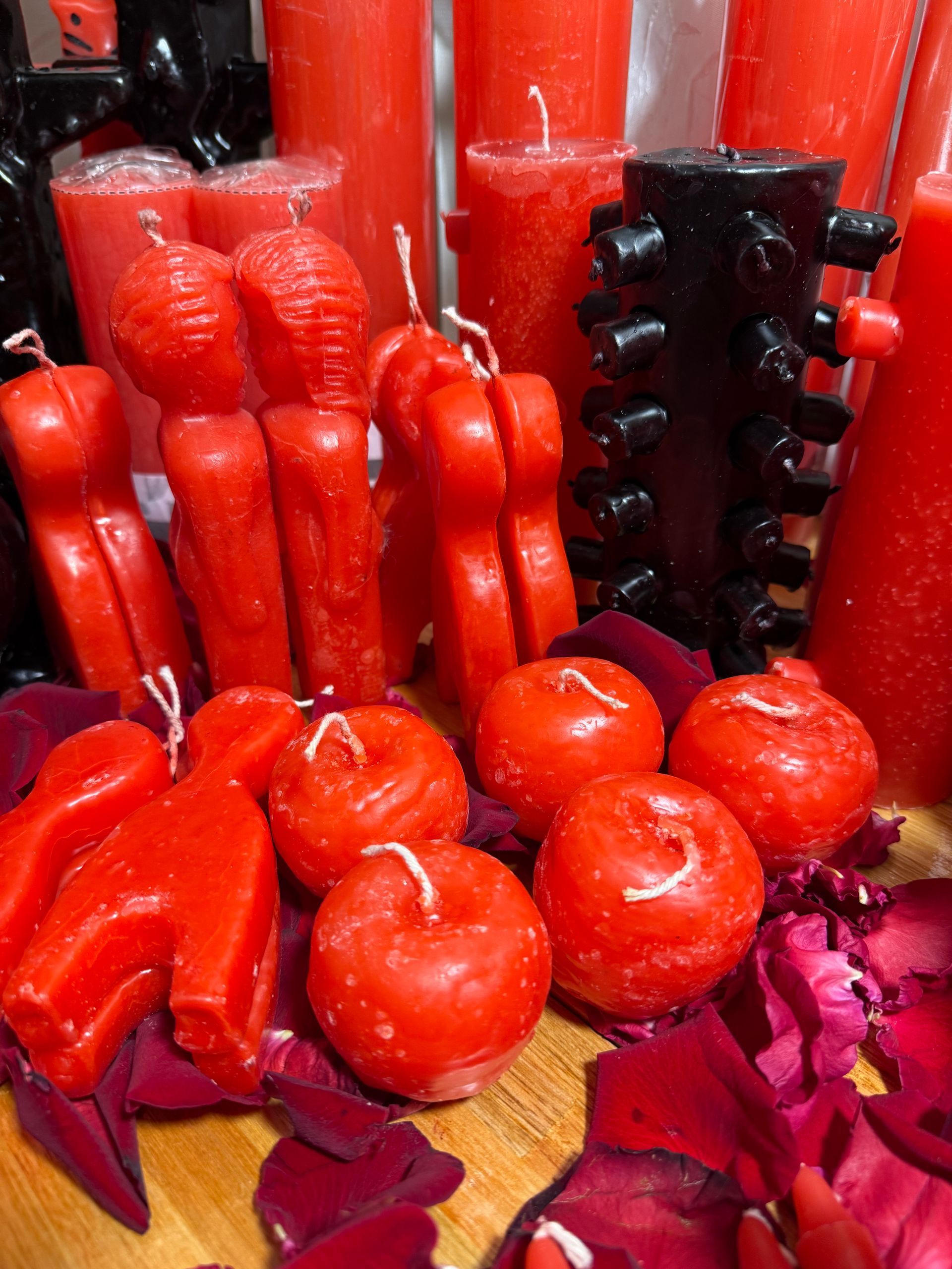 Mujer sentada en el suelo con cartas de tarot, cristales y flores.