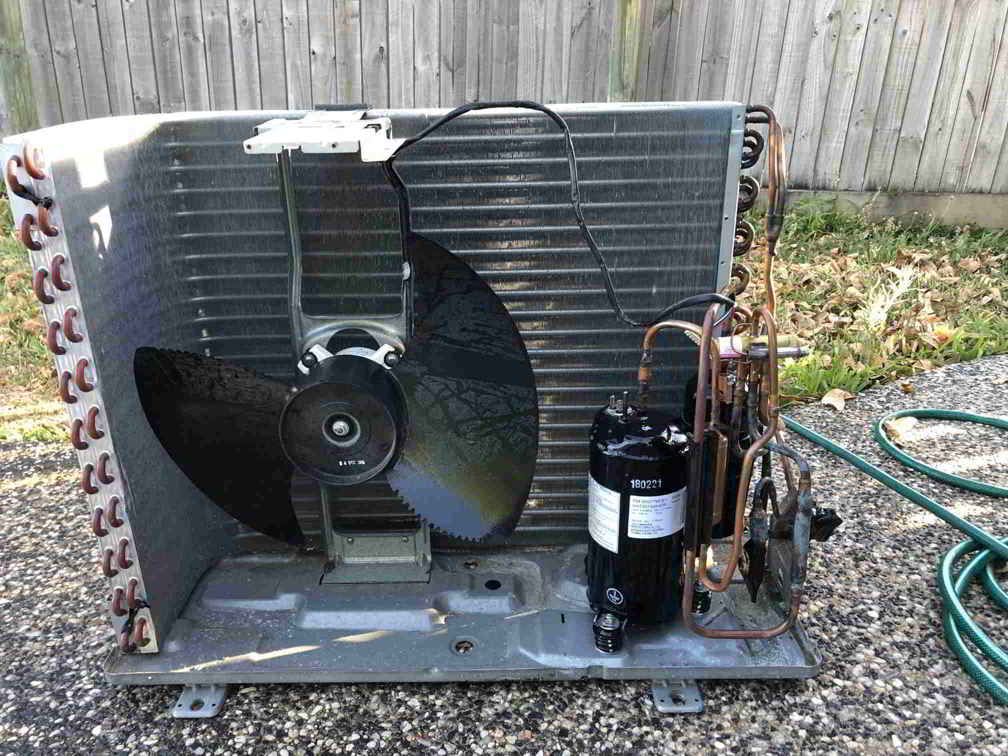 The Inside Of An Air Conditioner With A Fan And Compressor — Beards Refrigeration & Air Conditioning in Bucasia, QLD