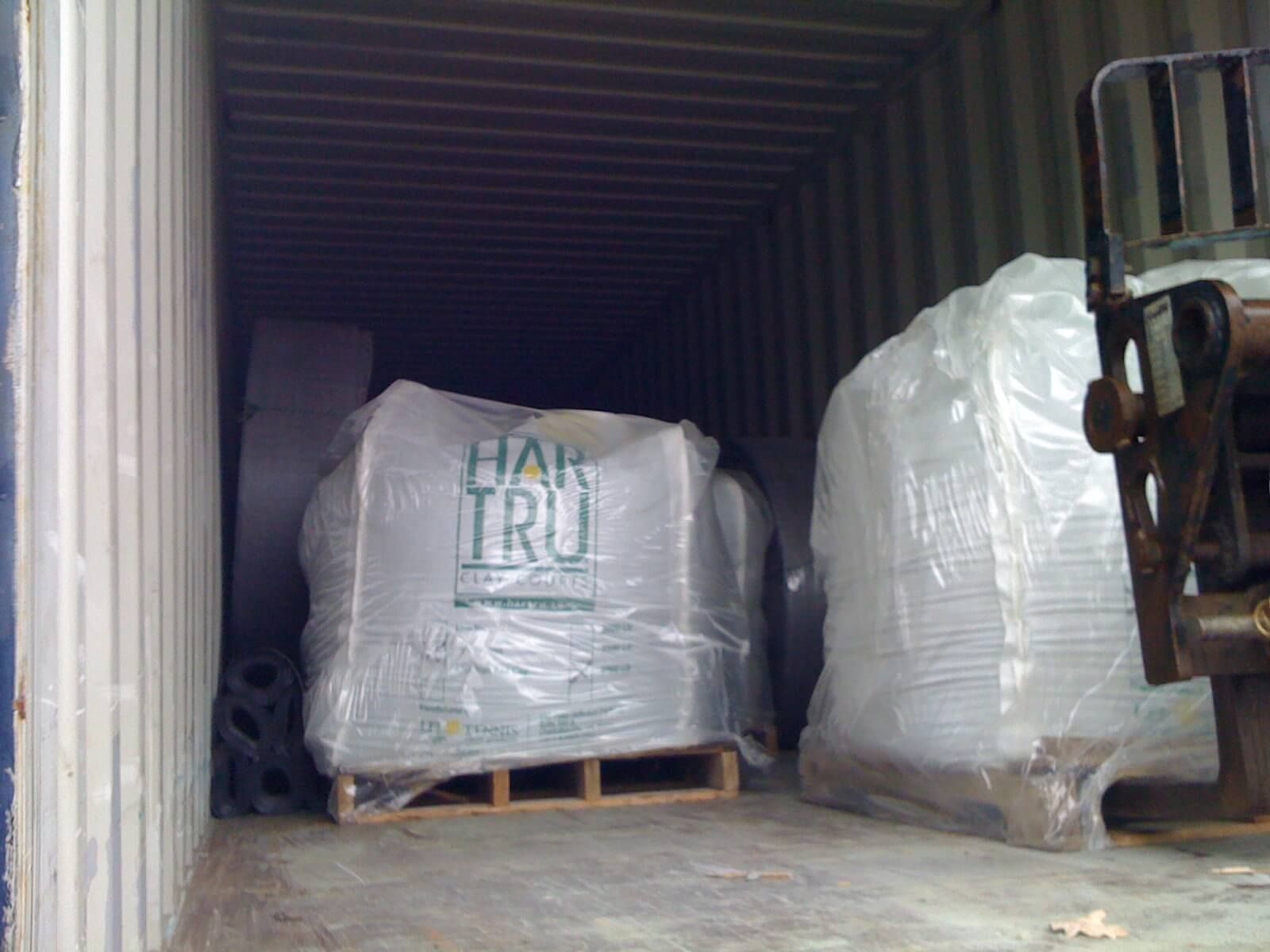 a forklift is carrying a large bag that says hair tru