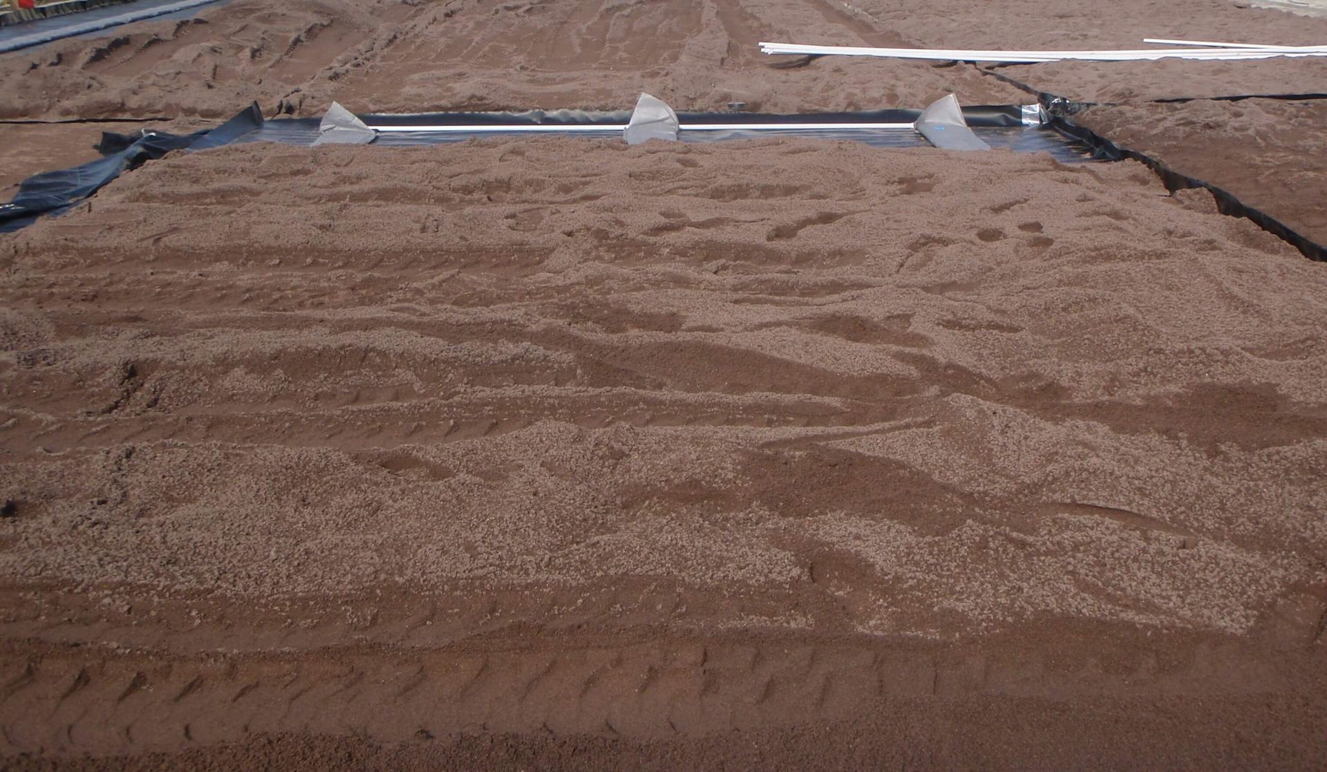 a large pile of dirt is sitting on top of a dirt field.