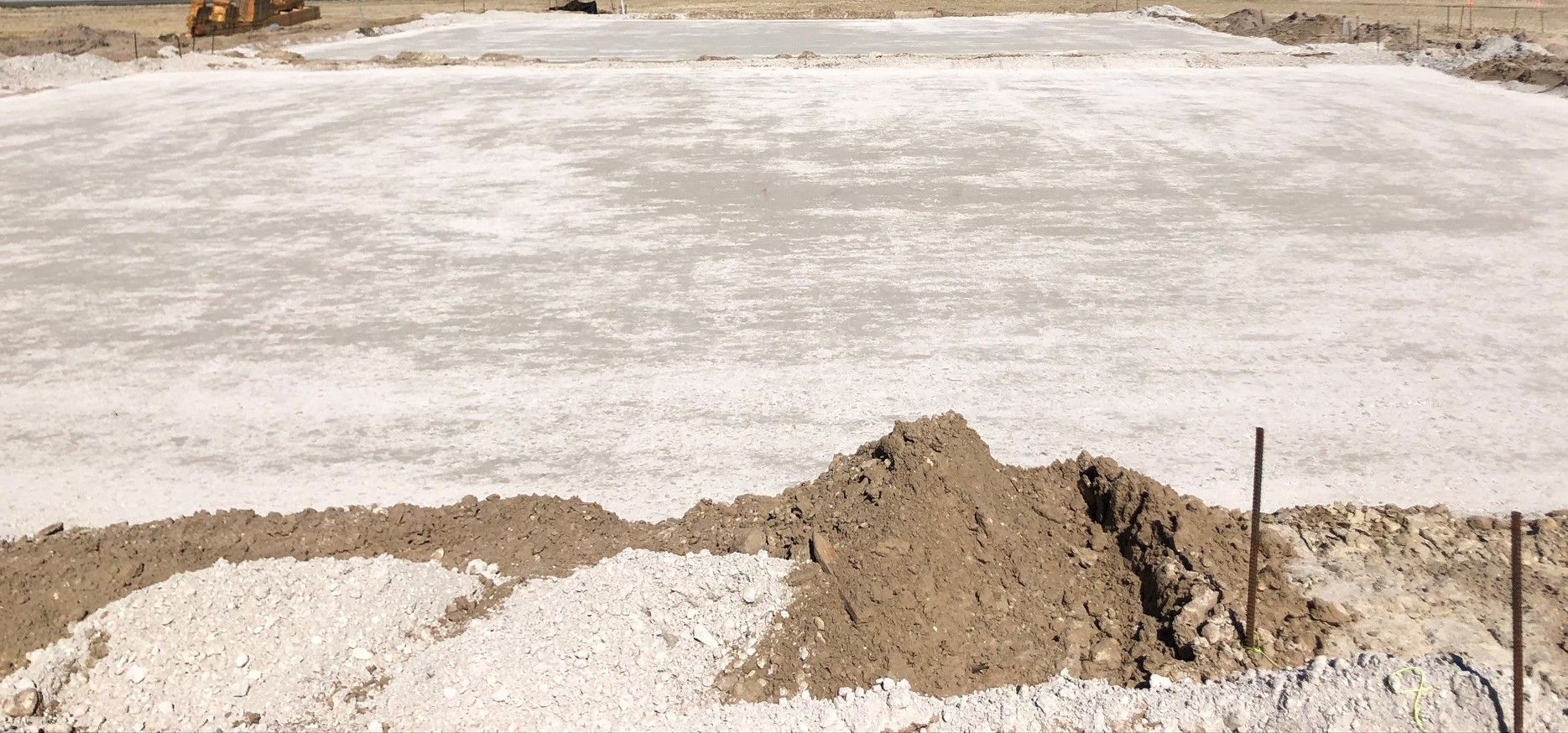 a pile of dirt is sitting on top of a concrete surface.