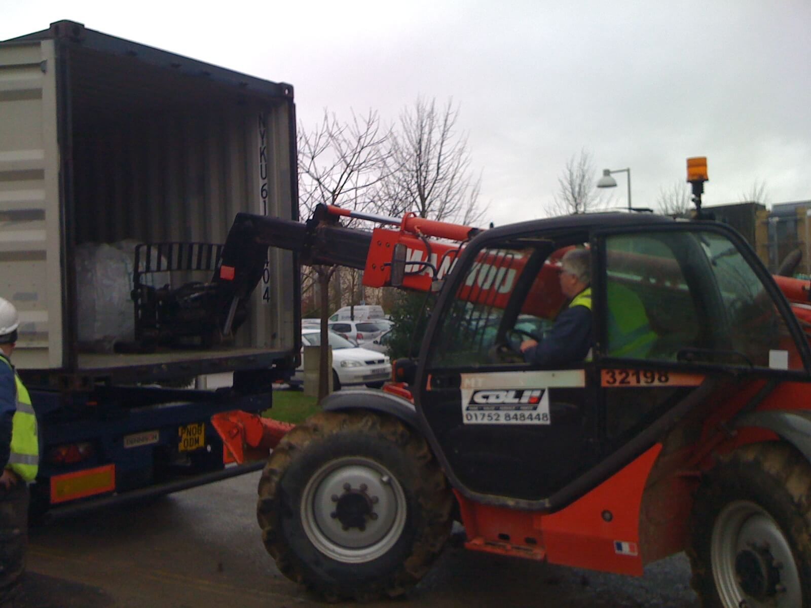a man is driving a forklift that says manitou on the door