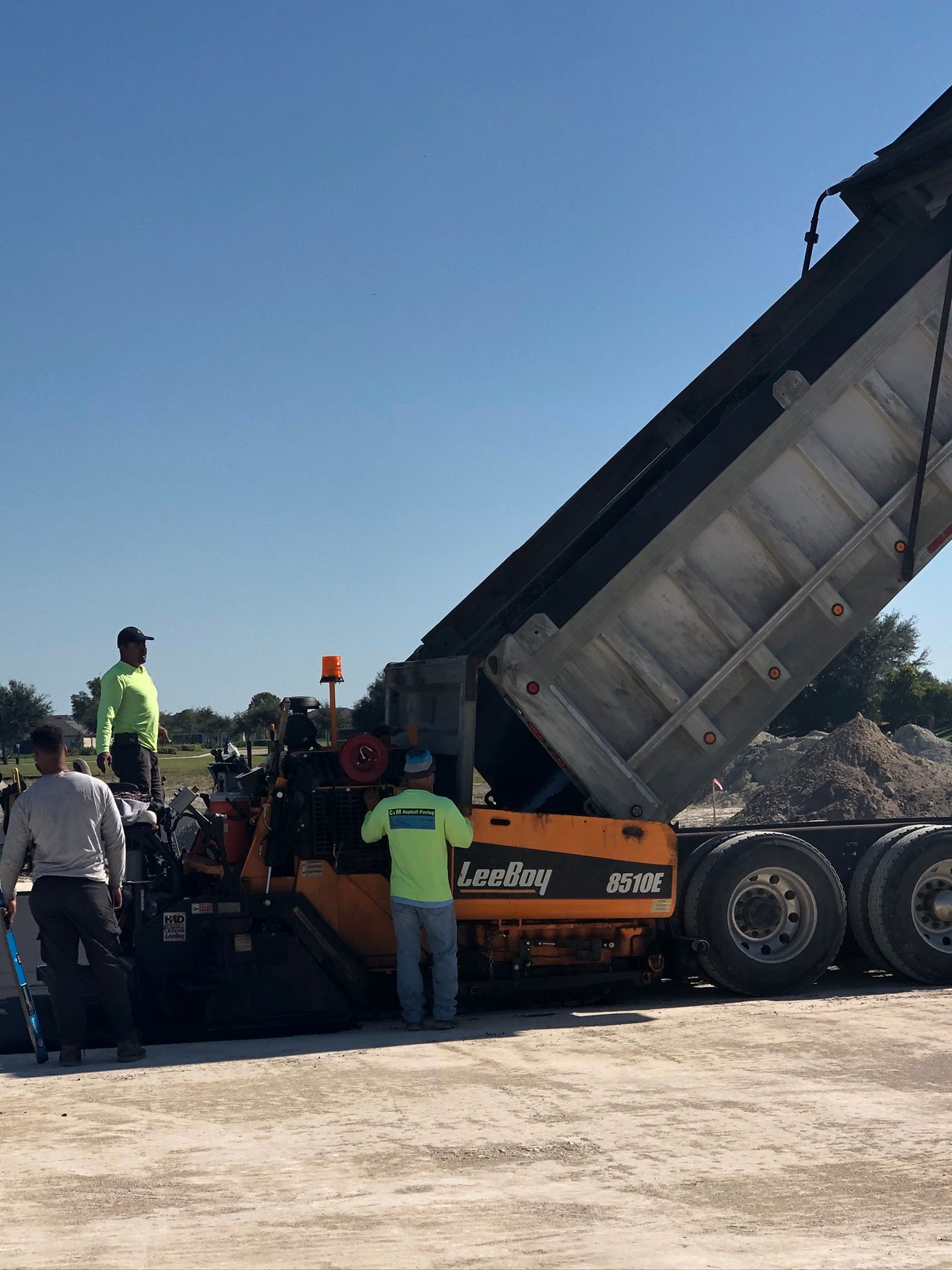 a large dump truck is being loaded with dirt