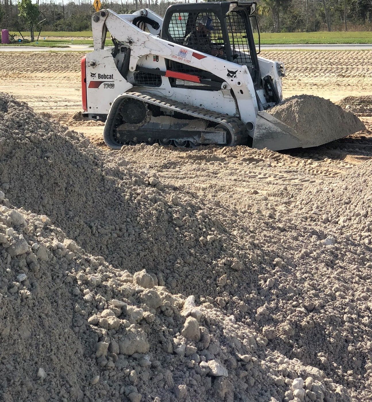 a bulldozer is moving dirt in a field.