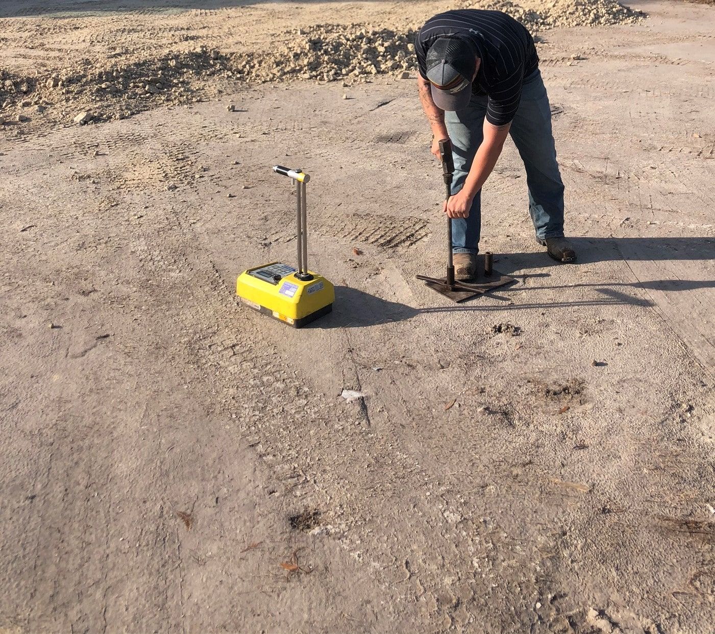 a man is using a shovel to dig a hole in the ground.
