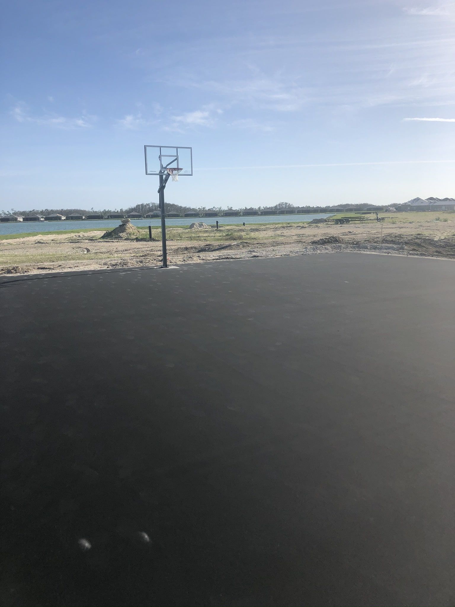 a basketball court with a view of a body of water in the background