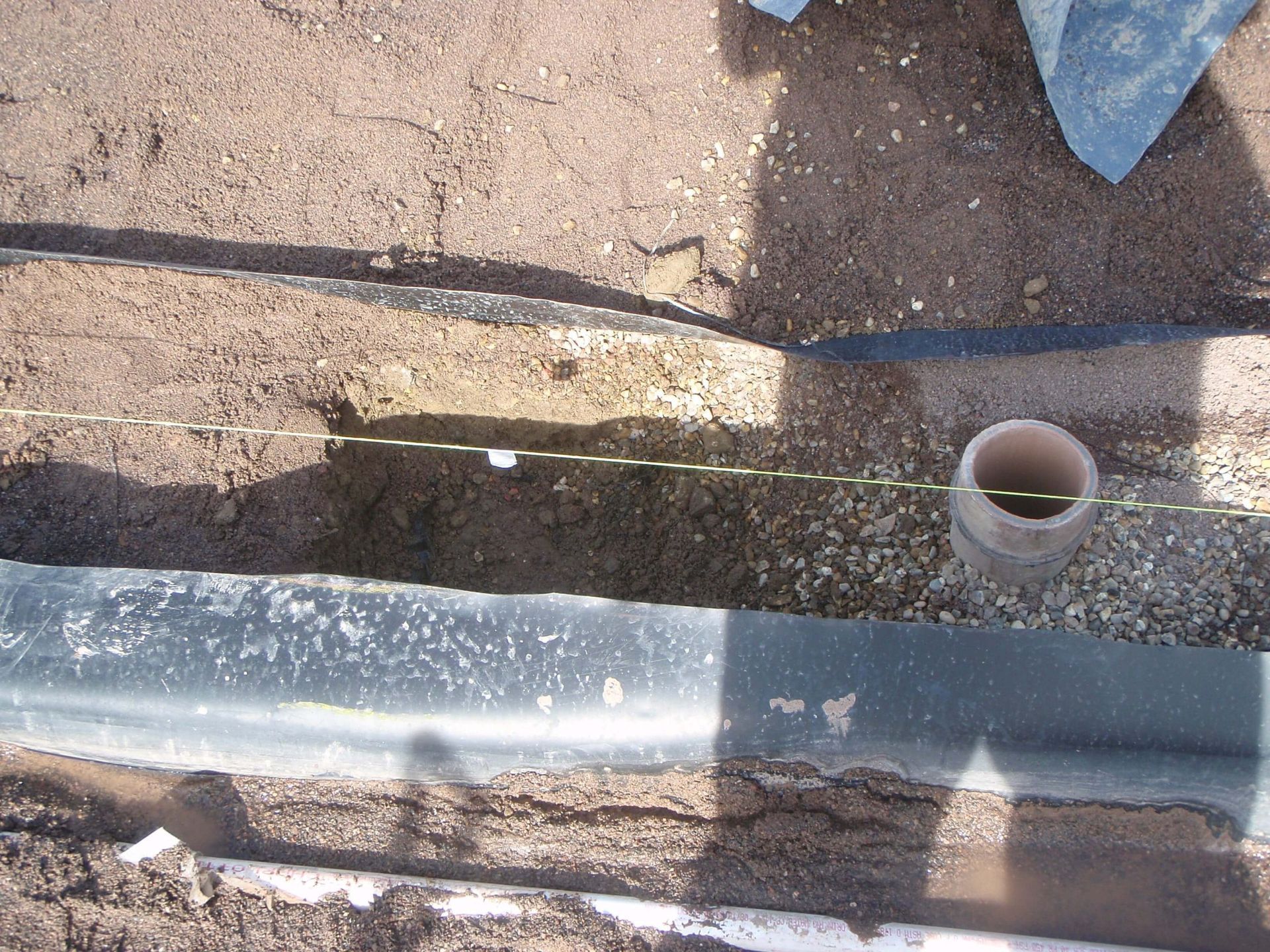 a hole in the ground with a pipe in it