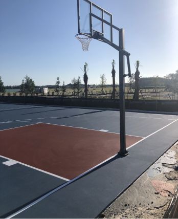 A basketball court with a basketball hoop in the middle