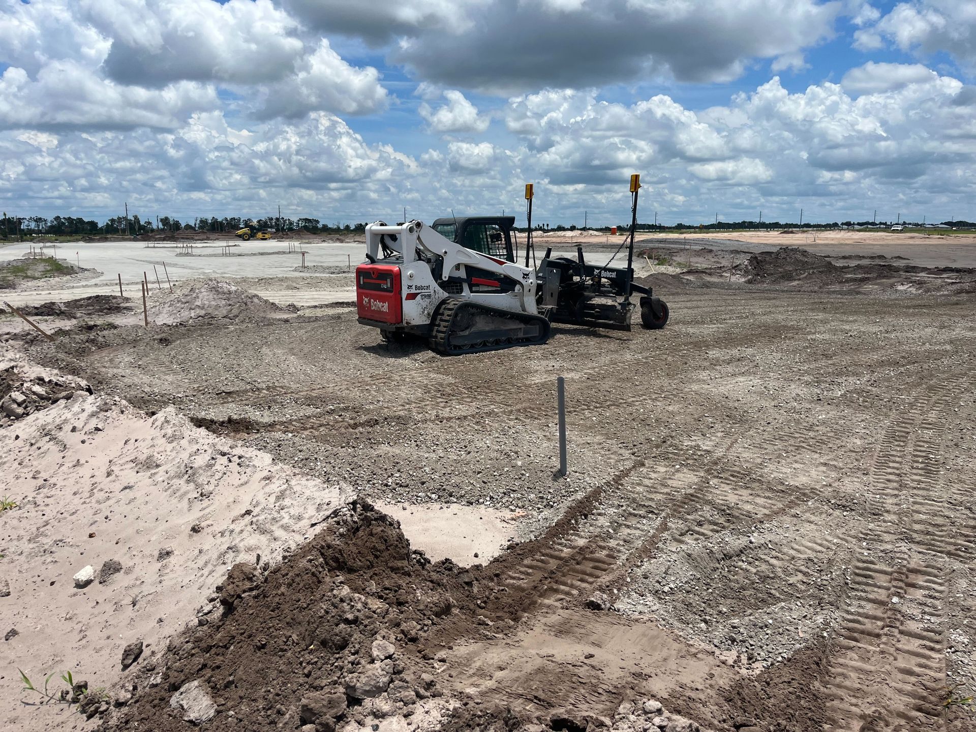 a bulldozer is sitting in the middle of a muddy field.