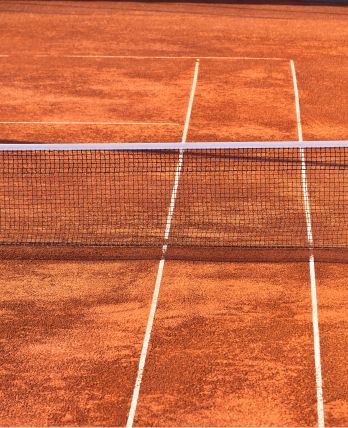 A tennis court with white lines and a net