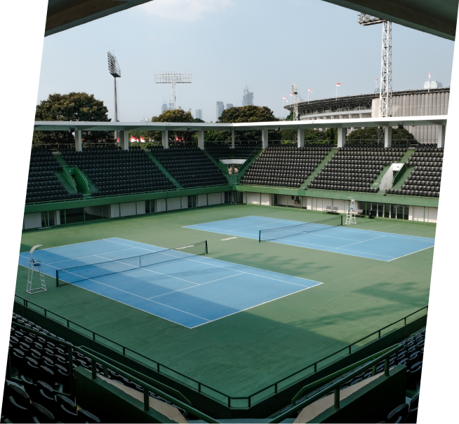 a tennis court in a stadium with empty seats