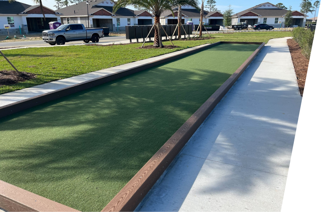 A bowling alley in a residential area with a truck parked in the background.