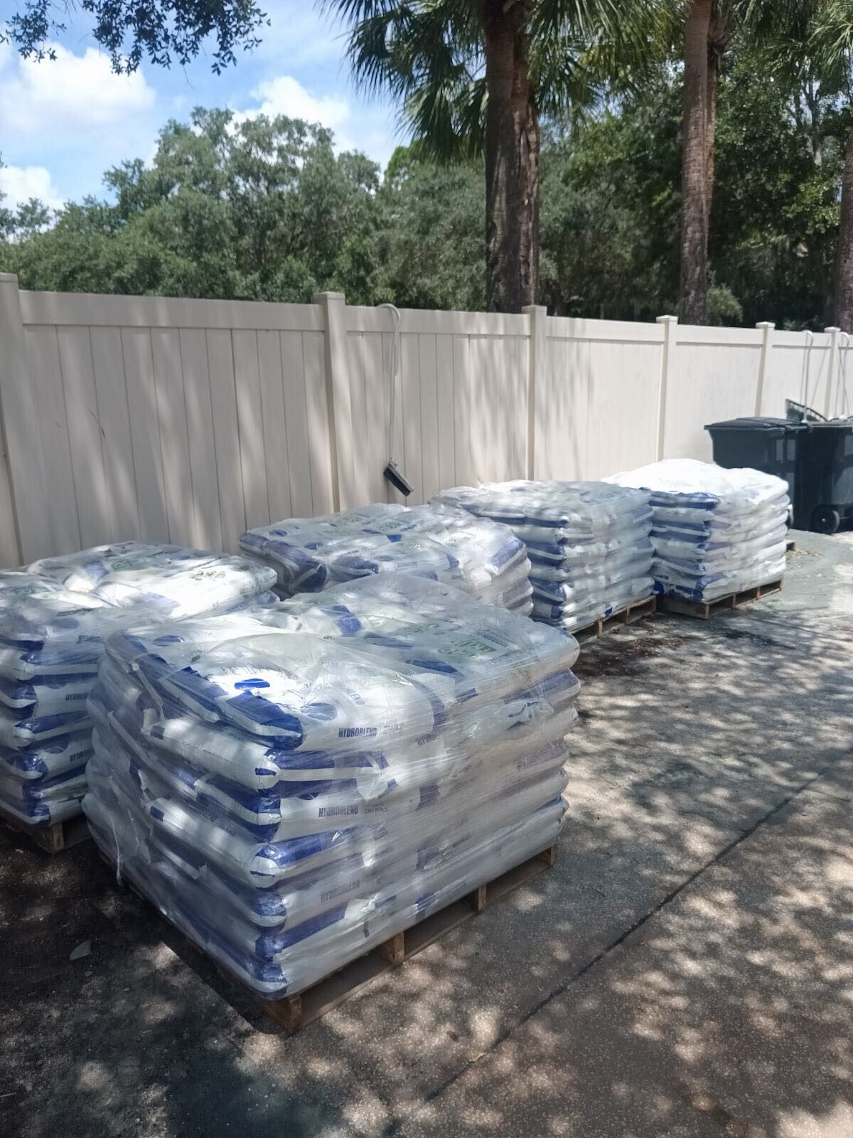 a man wearing a mask is standing next to a bag of green powder.