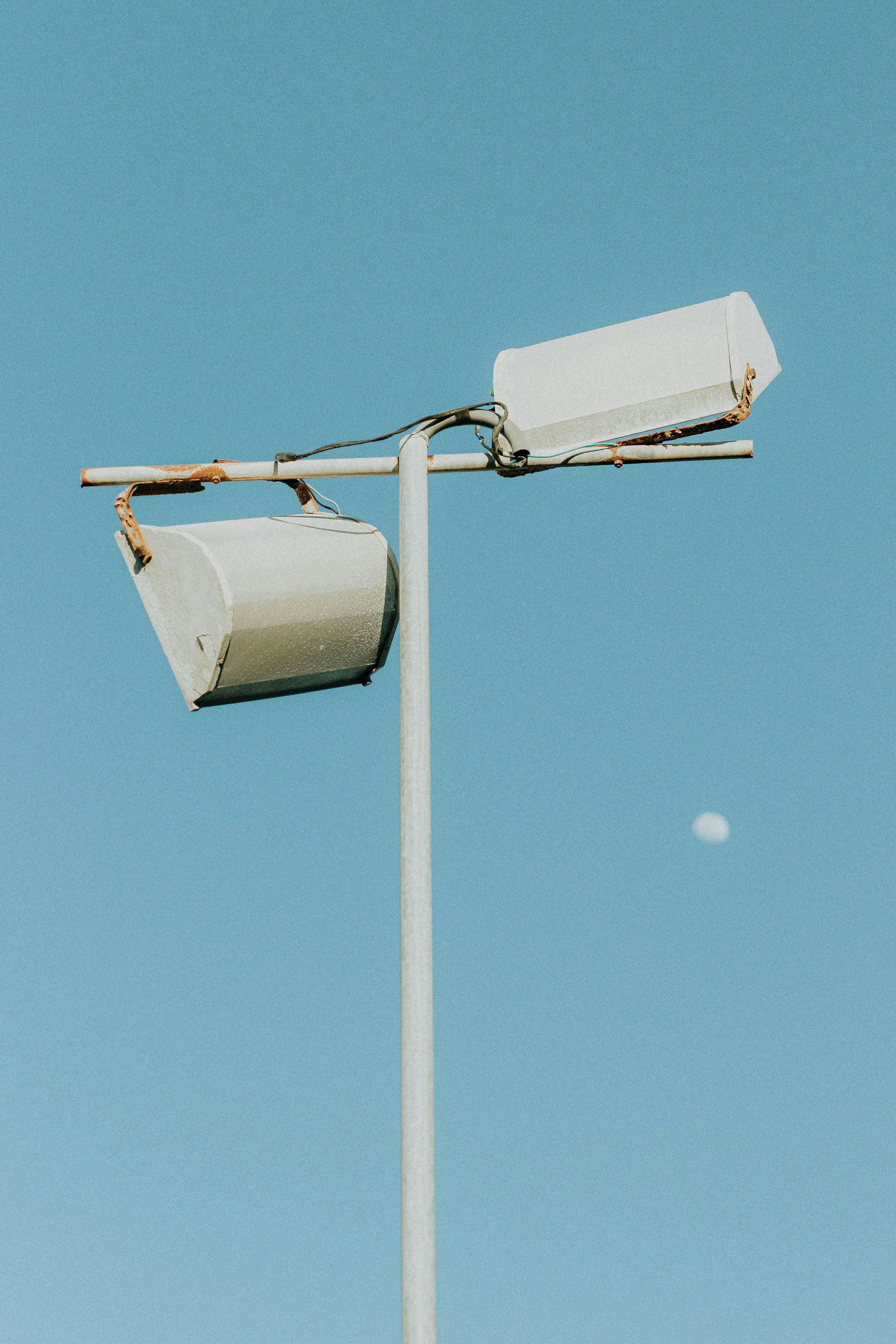 A street light with a blue sky in the background