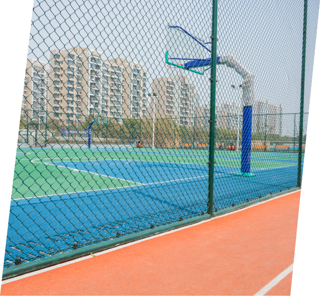 a basketball court with a chain link fence around it
